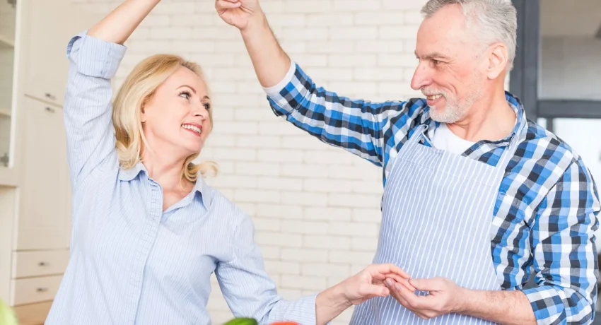 close-up-senior-couple-enjoying-dancing-kitchen