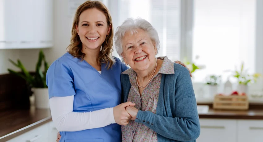 young-nurse-hugging-her-senior-woman-client